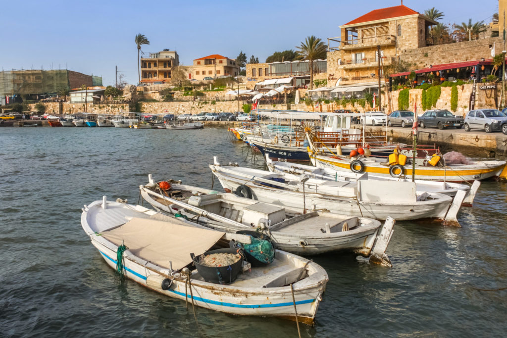 Photo of fishing boats and recreational boats docked at the Byblos harbor in Lebanon.