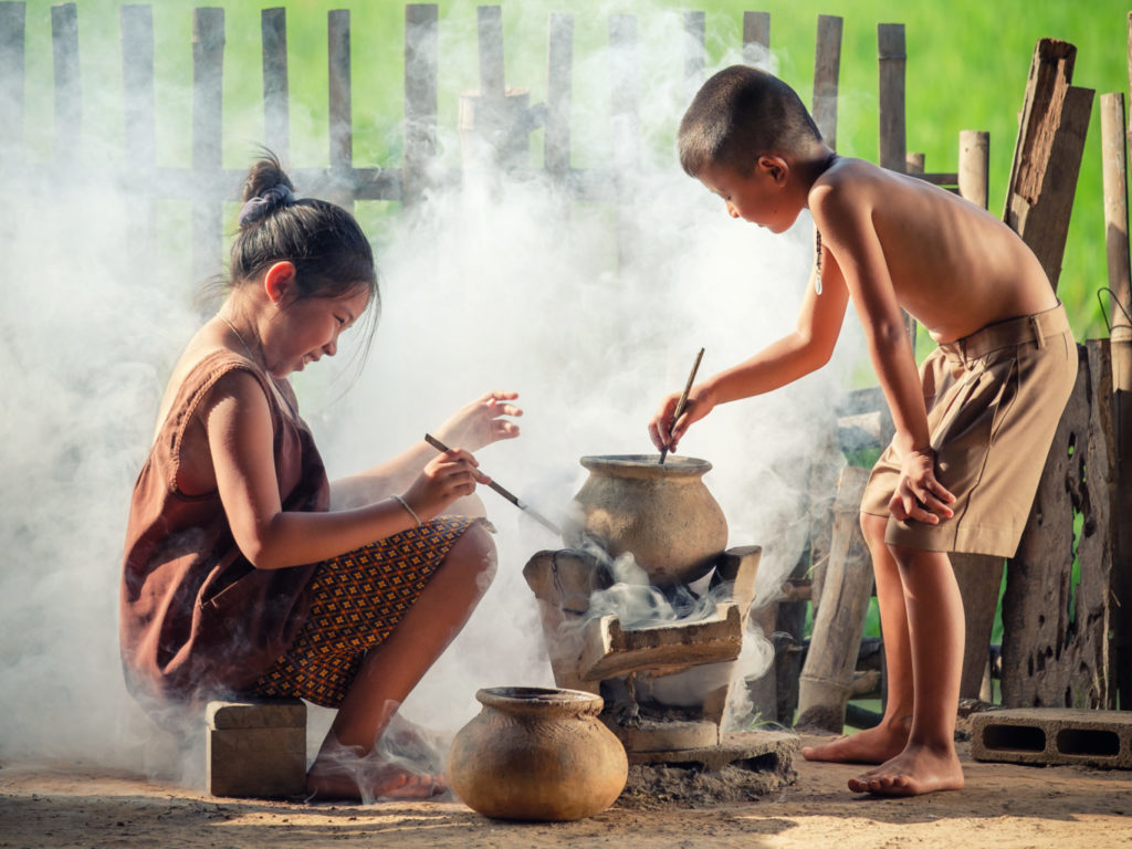 Asian children boy and girl are cooking in the Kitchen of the Countryside of Thailand, living in countryside, Countryside Thailand.